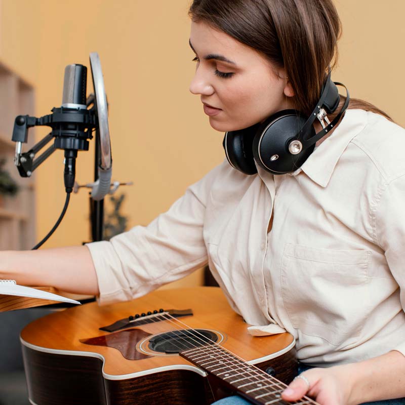 Girl playing guitar at music room