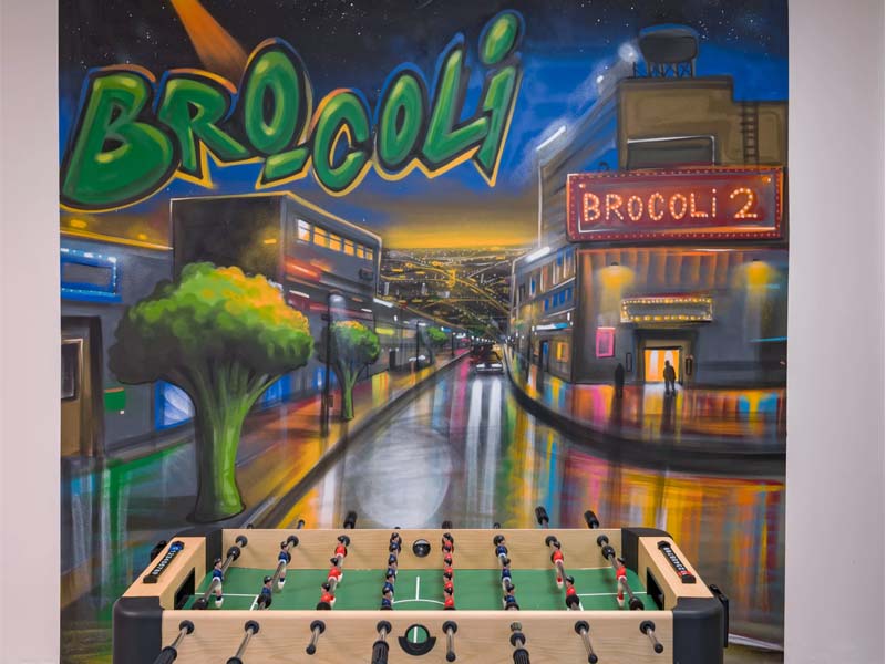 Table soccer at bro-coli Střížkov with painting on a wall