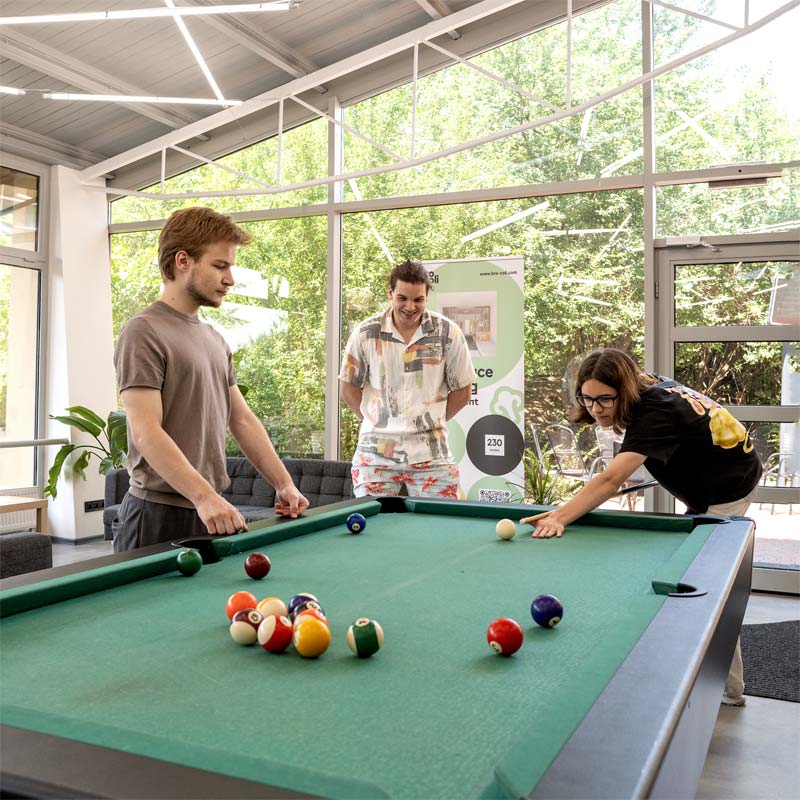 Group of friends playing pool at bro-coli